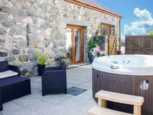 Private hot tub on the secluded patio | Bwthyn Meulan, Llandwrog, near Caernarfon