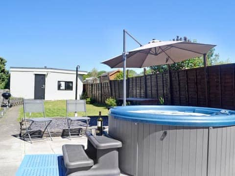 Relaxing hot tub | Ty Bryn Cottage, Kenfig Hill, near Bridgend