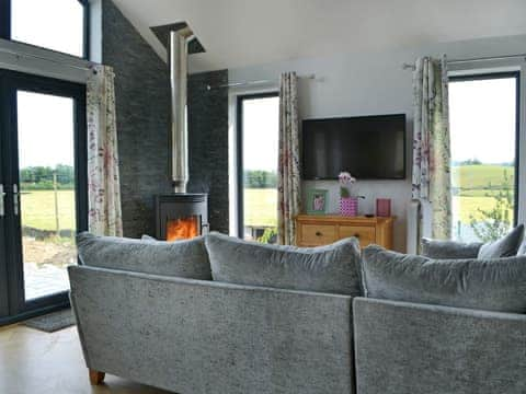 Stylishly furnished living area with wood burner | Sprint Lodge, Burneside, near Kendal