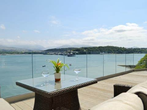 Amazing views across the Menai Strait from the decked terrace | Tan Y Fford, Glyngarth, near Beaumaris