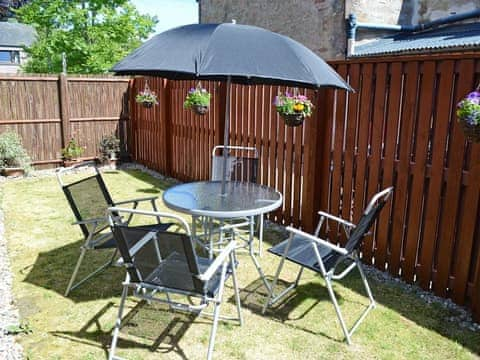 Relaxing garden with garden furniture | Acorn Cottage, Conon Bridge