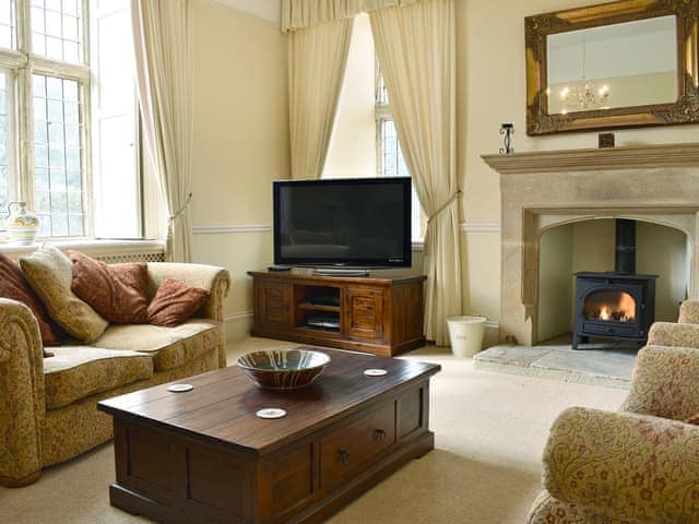 Welcoming living room with wood burner | The Farmhouse - Round Chimneys Farm, Glanvilles Wootton, near Sherborne