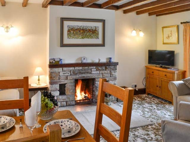 Living space with open fireplace | Swaledale Cottage - Swaledale and Ellerbeck Cottages, Caldbeck, near Keswick