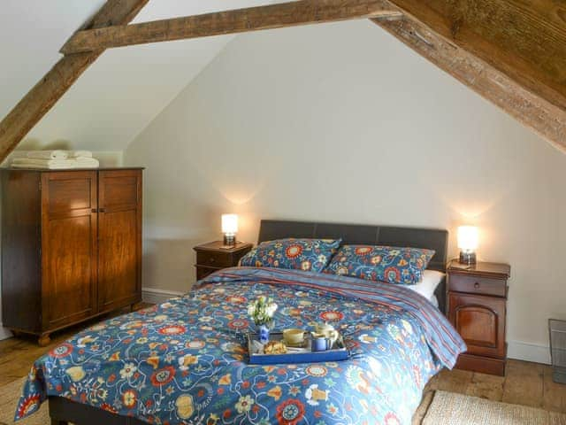 Relaxing double bedroom with exposed wood beams | Greenyard Cottage, Longhorsley, near Morpeth