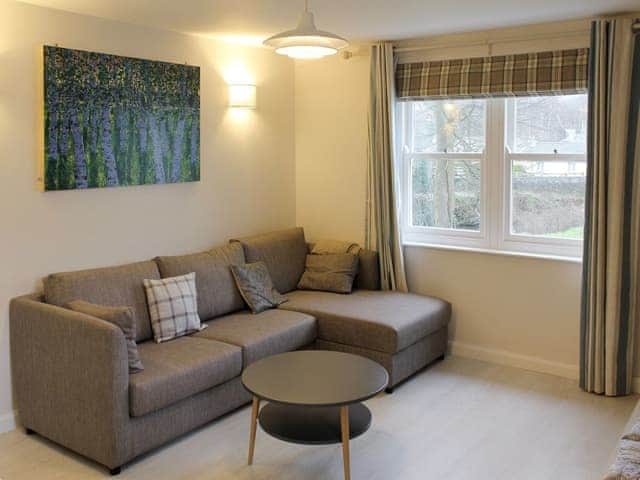 Comfy seating within living room | 12A Elm Court - Greta Grove Apartments, Keswick