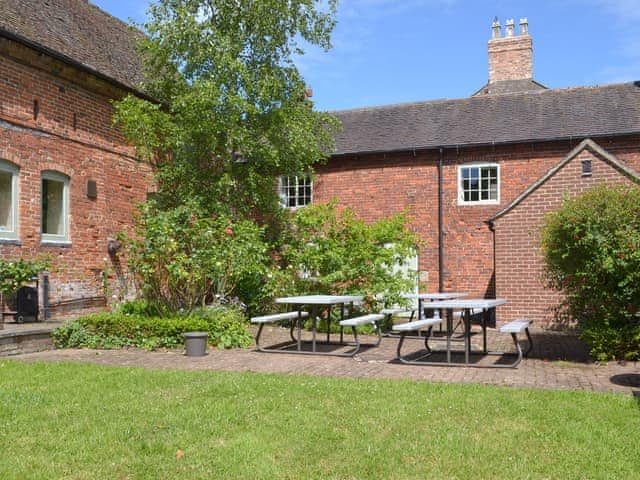 Shared patio area with outdoor seating. Ideal for a BBQ or a family gathering. | Burdett&rsquo;s Cottage, Repton Cottage, Foremark Threshing Barn - Foremark Cottages, Milton, near Repton