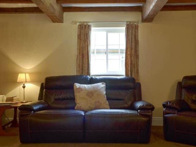 Spacious living room with exposed wood beams | Burdett&rsquo;s Cottage - Foremark Cottages, Milton, near Repton