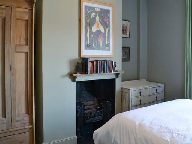 Double bedroom with feature fireplace | Blackbird House, Alnwick