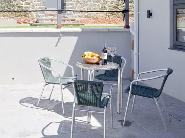 Patio area with outdoor furniture | Deepwater Point Apartment, Torquay