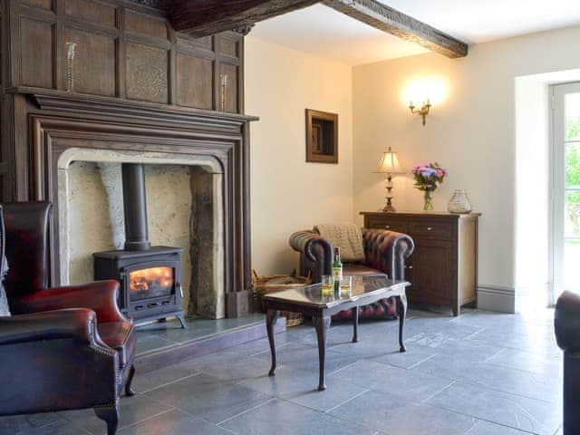 Welcoming living room with wood burner and French doors leading to garden | Souterstead, Torver, near Coniston