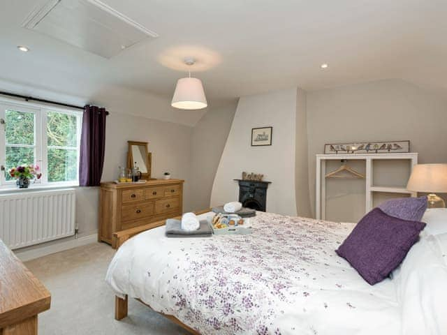 Spacious double bedroom with feature fireplace | Sunnyside, Ludham, near Wroxham