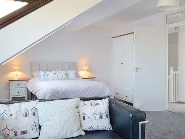 Master bedroom suite with seating area | Harbour Gates, Maryport