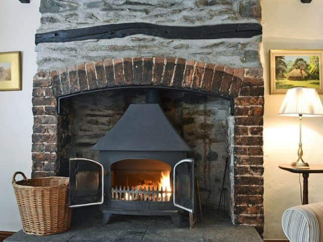 Characterful living room with beams and wood-burning stove | Oaks Farm Cottage, Ambleside