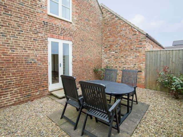 Enclosed patio area with outdoor furniture | The Mill House - Meals Farm Cottages, North Somercotes, Mabelthorpe