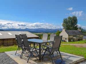 Stunning views of the majestic Cairngorm mountain range from the sitting out area | Wester Laggan Cottage, Dulnain Bridge, near Grantown-on-Spey