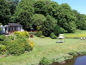 View of the chalet from the nearby bridge | Harperfield Chalet, Lanark