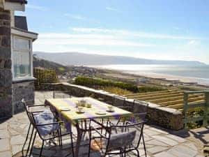 Paved upper patio with outdoor furniture | Rhosmair, Llanaber, near Barmouth