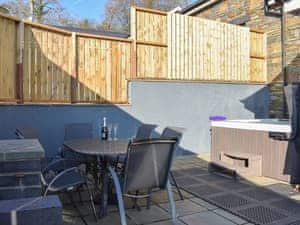 Paved patio area with hot tub and barbecue | Stabl - Bwlch Y Person Barns, Dihewyd, near Aberaeron