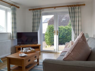 Living room with patio doors | Miners Cottage, Clowne, near Chesterfield