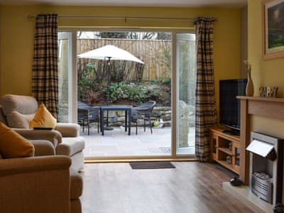 Living room with patio doors | Old Orchard Cottage, Trethurgy, near St Austell