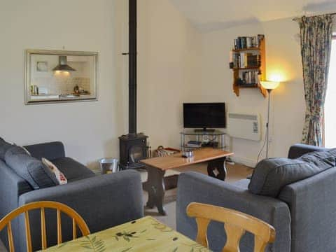 Delightful open plan living space with a cosy wood burner | Partridge Cottage, Gristhorpe near Filey