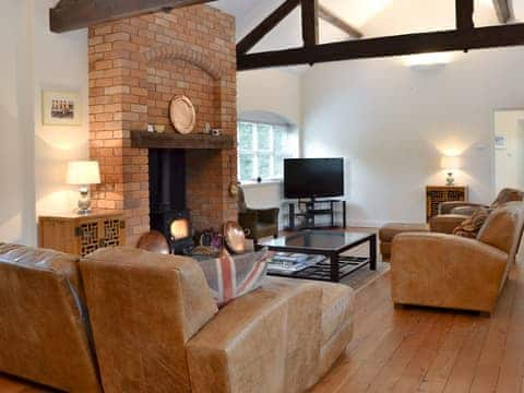 Spacious living room with a cosy log burner | The Old Stables, Standon