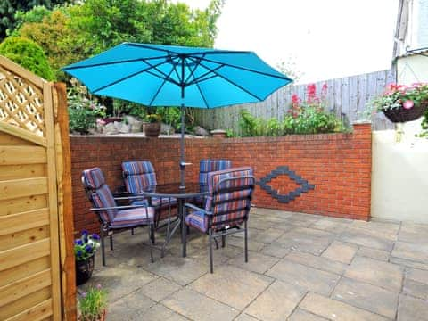 Paved patio area with outdoor furniture | Two Beaches, Paignton