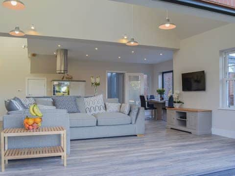 Wonderfully designed open plan living area with bi-fold doors to the garden | The Carriage House - Station House Cottages, Upper Poppleton, near York