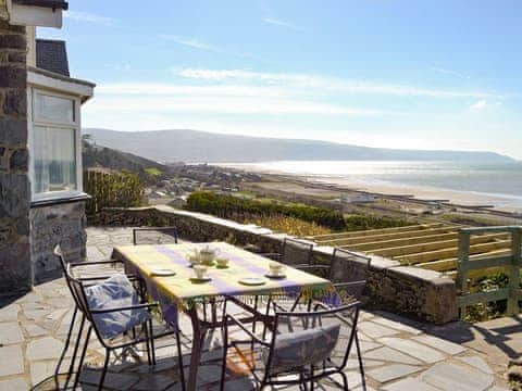 Paved upper patio with outdoor furniture | Rhosmair, Llanaber, near Barmouth