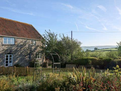 Enclosed lawned garden with sitting-out area and garden furniture | Hopedene Cottage, Weare, near Axbridge