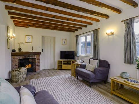 Living room with wood burner | The Old Saddlery, Colkirk, near Fakenham