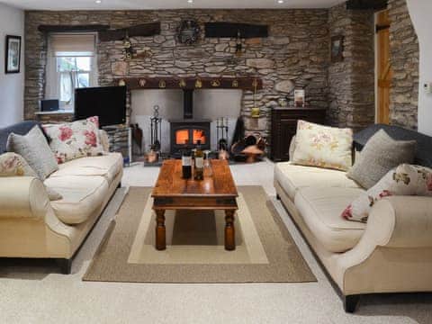 Warm and welcoming living room with imposing fireplace | Lynton Cottage, Combe Martin