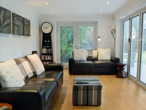 Light and airy living room with bi-fold doors leading to the garden | Dyffryn, Betws-y-Coed