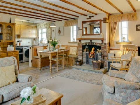 Charming open plan living space with cosy open fire | The Old Post Office, Thorpe Bassett, near Malton