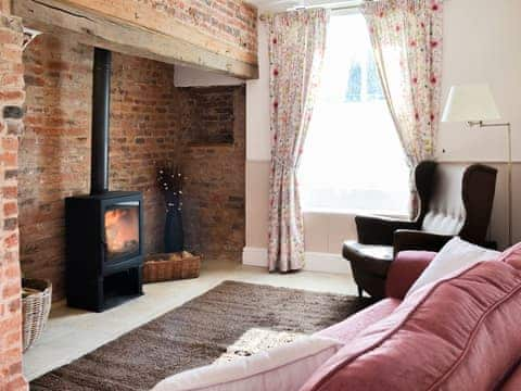 Cosy sitting room with inglenook fireplace and wood burner | West House Farm, Muston, near Filey