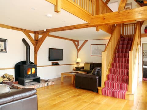 Open plan living space with warm and cosy wood burner | The Hayloft, Chislet