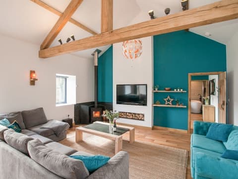 Wonderful beamed living area with woodburner | The Pendre Longbarn, Pont-Rhyd-y-Groes, near Ystrad Meurig