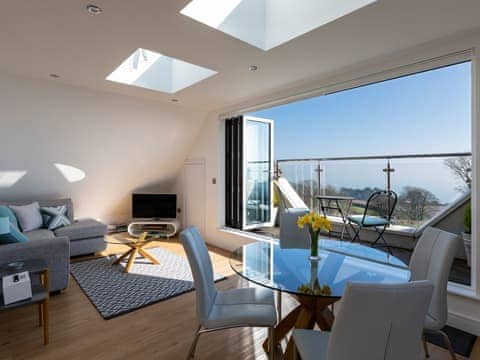 Contemporary open-plan living area with folding doors to balcony | The Penthouse @ Ocean Breeze, Stoke Fleming