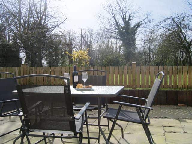 Enclosed courtyard with sitting-out area | The Granary - White House Farm Holiday Cottages, Knapton, near North Walsham