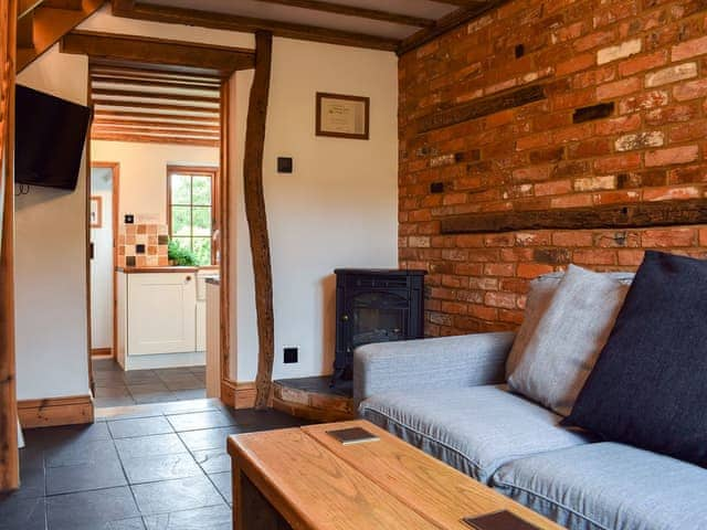 Living room with tiled floor and electric woodburner | The Old Bakery, Wendover, Aylesbury