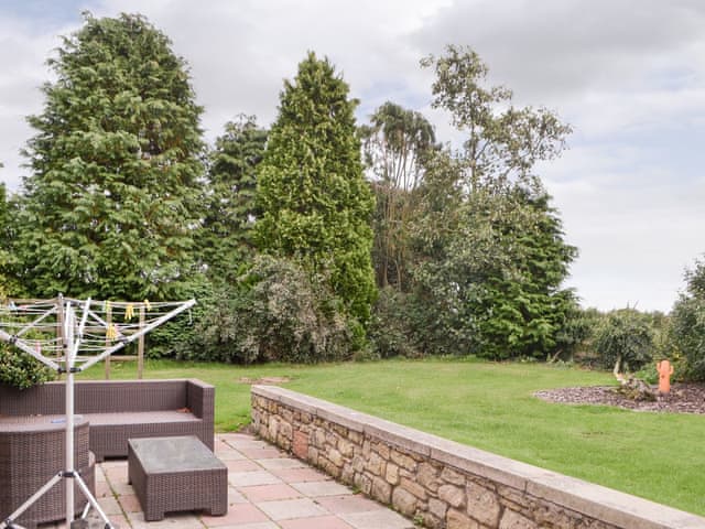 Patio area and garden | Dove Cottage - Railway Cottages, Acklington, near Amble