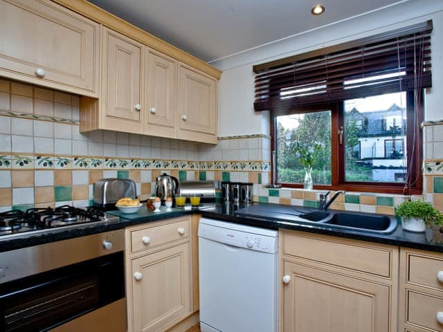 Tiled kitchen with garden views | Honeysuckle - Woodland Retreat, Wadebridge