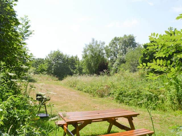 Outdoor seating area within the garden | Great Meadow - Sherrill Farm Holiday Cottages, Dunterton, near Tavistock