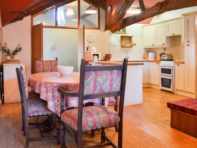 Dining/kitchen area with reclaimed beams | Birkerthwaite Cottage - Birkerthwaite Cottages, Eskdale