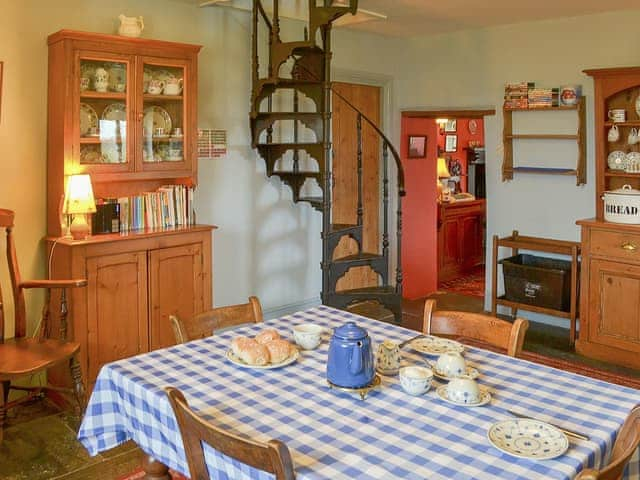 Country style kitchen with spiral staircase to upper level | Downhouse - Downhouse Cottages, Trebarwith, near Delabole