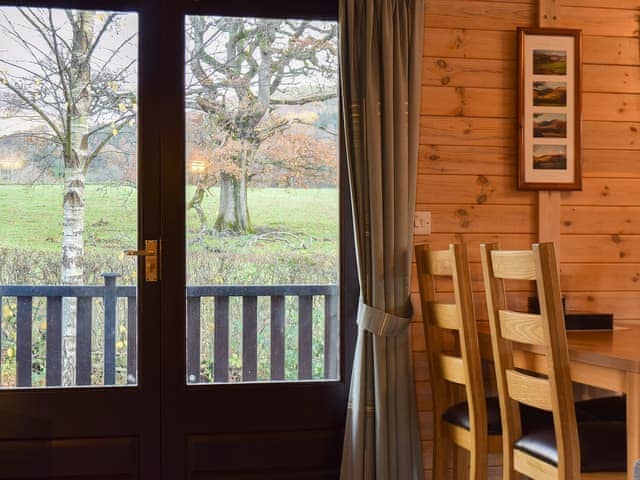 Modest dining area next to double doors to the verandah | Whinny Brow - Burnside Park - Burnside Park, Keswick