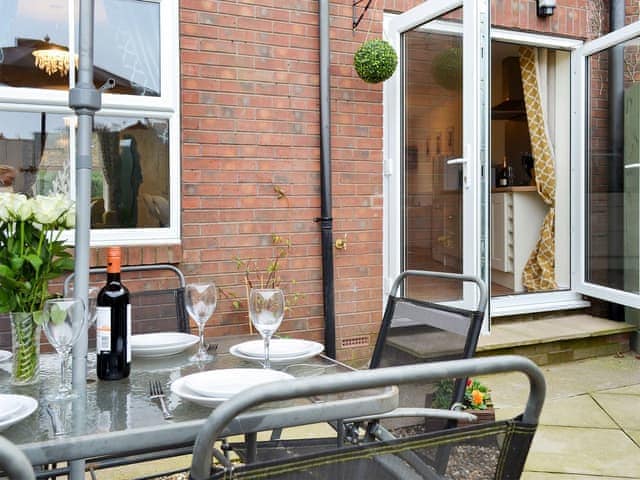 Small enclosed courtyard with sitting-out area, garden furniture and BBQ | The Horseshoes, Hornsea