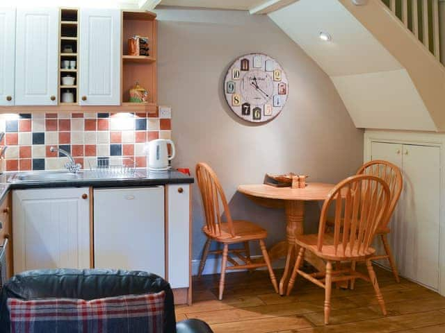 Modest dining area and adjacent kitchen | Larch Cottage, Dunstan, near Alnwick