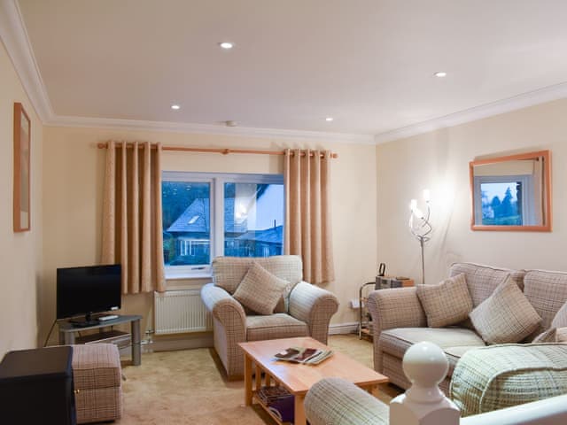 Comfortable living area with wonderful view of Lake Windermere | Woodside Cottage, Ecclerigg, near Ambleside