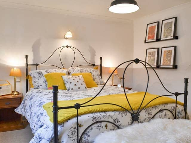 Romantic double bedroom with antique style bed | Sage Cottage, St Columb Major